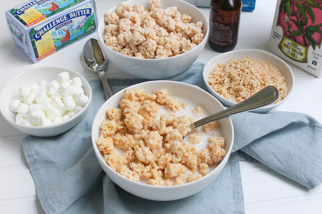 Bowls filled with Rice Krispie Treats Cereal ingredients and a full bowl of the finished cereal with milk at the center. 