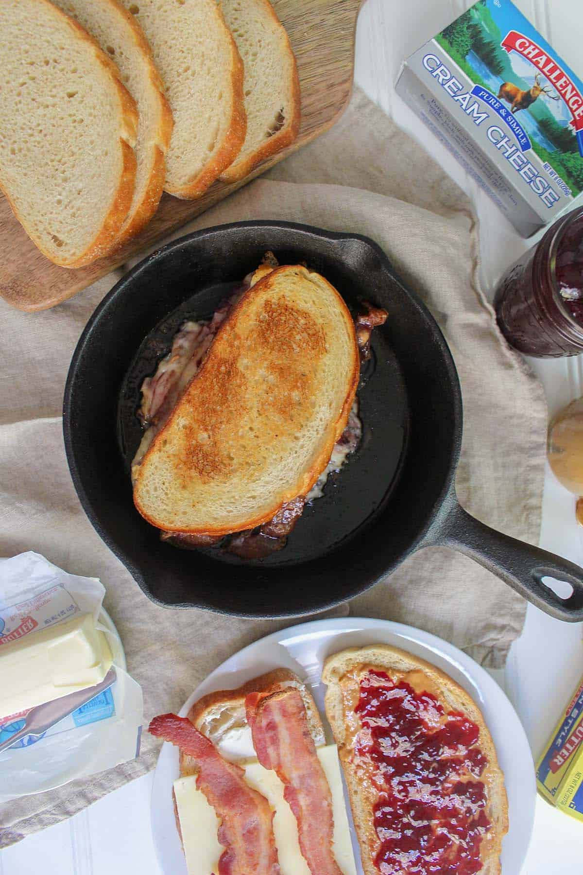 Delicious grilled cheese with peanut butter, jelly, and crispy bacon on bread.