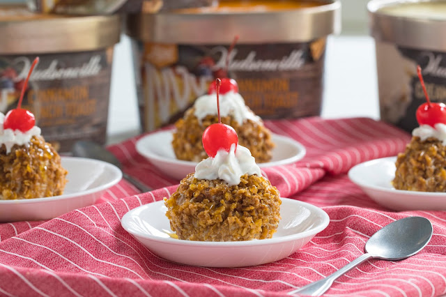 Easy "Fried" Ice Cream in a bowl with whipped cream and cherry on top. The fried ice cream is made of ice cream coated in crushed cereal.