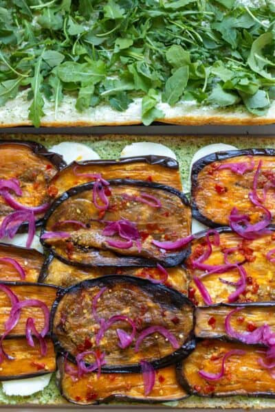 Make-ahead eggplant focaccia sandwich with roasted eggplant and pickled onions.
